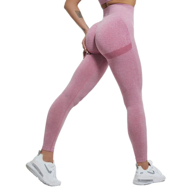 Person wearing pink leggings on a white background